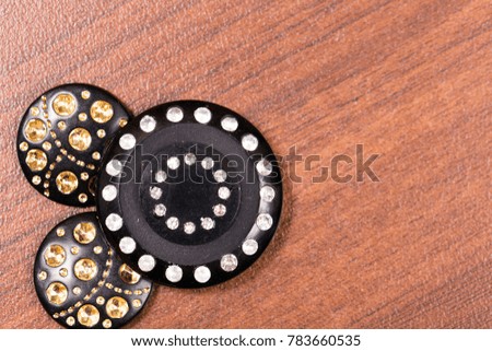 Various vintage buttons on a wooden background. Space for text