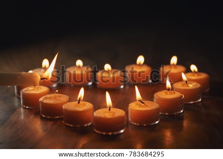 setting tea warm candles in heart shape on wood table