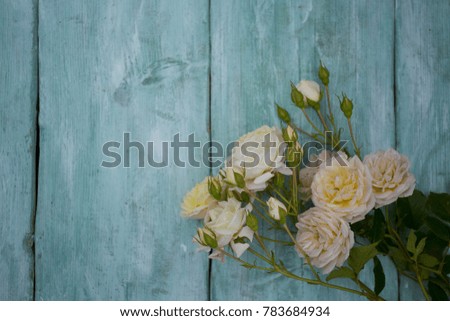 beautiful white roses on wooden surface