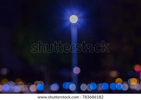 Blurry images of a lamp pole by the Thames riverbank in London