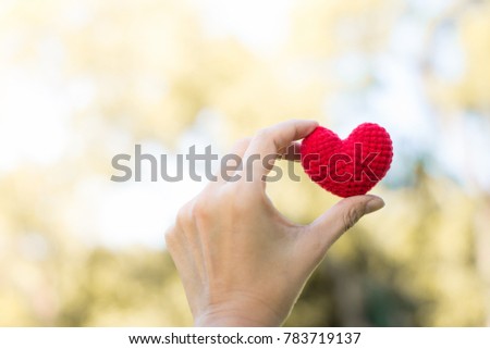 Hand holding red heart on bokeh blurred background,valentine day concept Royalty-Free Stock Photo #783719137