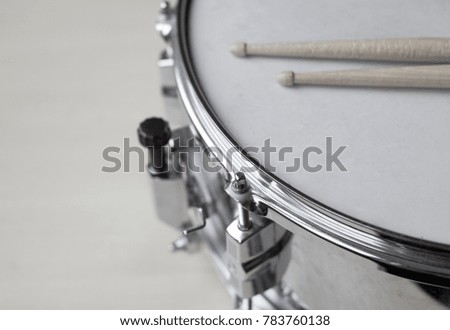 
Drum and wooden sticks. Black and white photo.