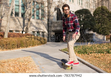 A Student about to Ride a Skateboard Towards Direction of Path.