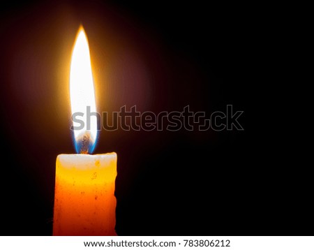 One Candle light on black background, Candlelight shines light into the destination.