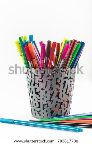 colored Pens in iron basket on the white background
