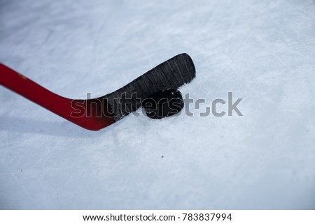 Hockey stick and puck on natural ice