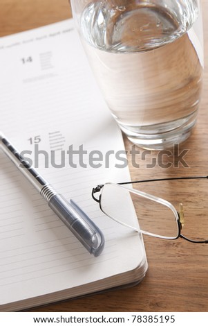 writing concept:pen, glasses, notes, glass of water