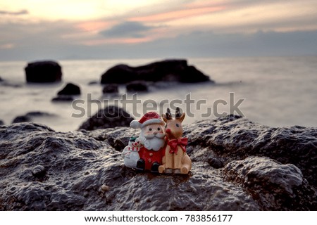 Santa summer see sunset on the rock with reindeer relax background