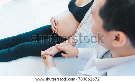 The doctor is diagnosing pregnant women.