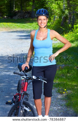 Young woman cyclist riding  in the park