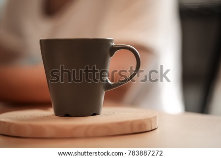 Brown dark cup of strong coffee or tea on wooden table desk in the ofice. Business background. Morning concept. Hot drink for wake up.