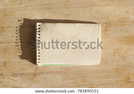 Vintage notepad on a butchers block on a sunny day