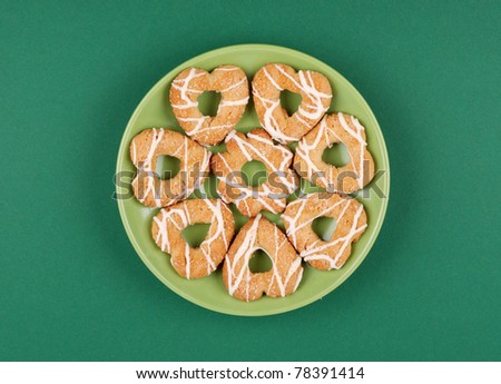 Cookies with glaze on green background