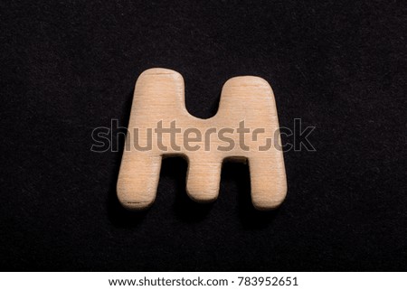 Wood Alphabet on Black Background letter M