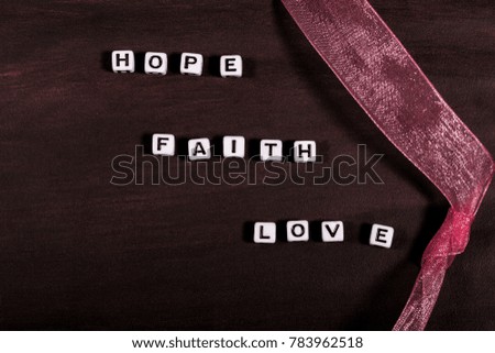 Words Hope Faith and love on Brown background