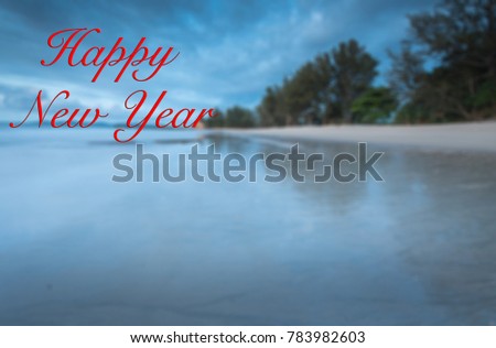 Words " HAppy and Prosperous NEw Year" written on blurred sunset sesacape background. Happy new year concept.