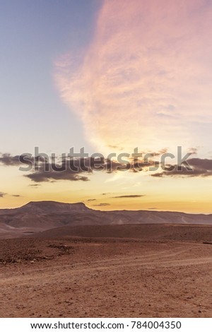 Vertical photo morning colorful landscape of magic sunrise in judean desert in Israel. Outdoor nature with nobody on photo. Deep blue sky and clouds, mountains and rocks. Magic dawn sunrise