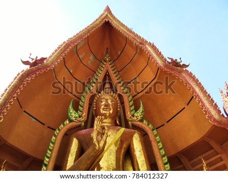 Big Golden Buddha statue in Tiger Cave Temple at Kanchanburi Provine, Thailand. Temple name in Thai Language called Wat Tham Sua. The temple of countryside in Thailand.