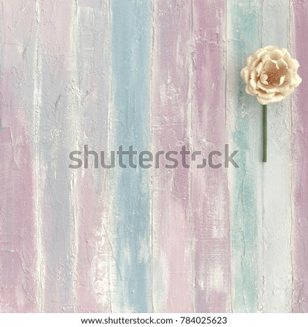 Delicate peony on a colored wooden background