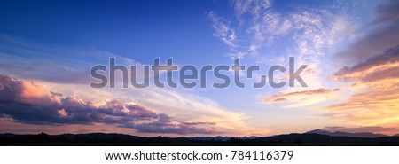 Horizon panorama mountain and dramatic twilight sky and cloud sunset background Royalty-Free Stock Photo #784116379