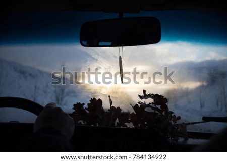 View from car window in winter snowy evening. Concept travel.