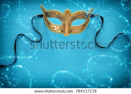 Image of elegant venetian mask over colorful background