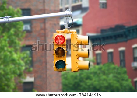 Red color traffic light with buildings in the background. Traffic light wallpaper.