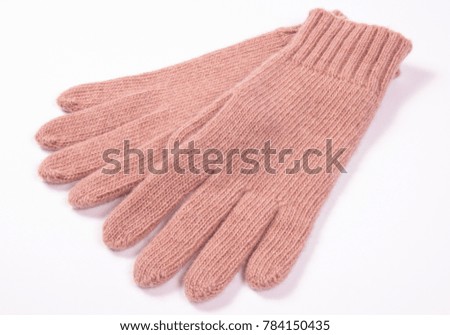 Pair of woolen gloves for woman on white background, warm clothing for autumn or winter.