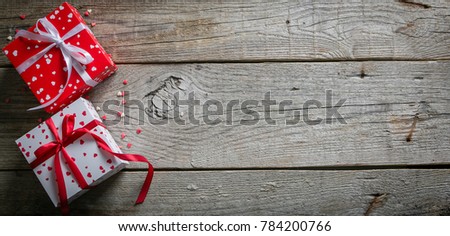 Valentine's day concept - presents, candy, glasses on rustic wood background