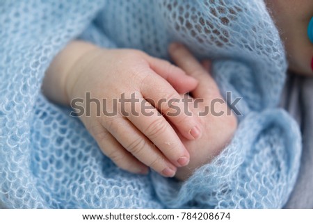 hands of a newborn baby. hands on blue . children's hands
