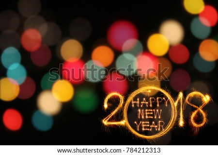 Happy new year text and 2018 written with sparkle fireworks on colorful bokeh background align right and text space