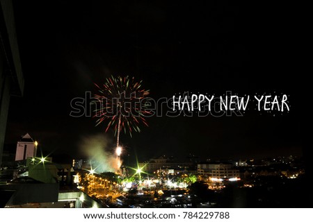 Blur image of New Year Eve Fireworks Display Show with word "happy new year" . soft focus,motion blur due to long exposure shoot. visible noise due to high ISO.
