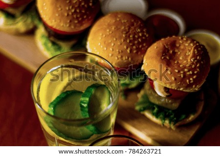 mini burgers with meat, vegetables, cheese and other toppings, bread sprinkled with sesame seeds, mini fast food, tasty set