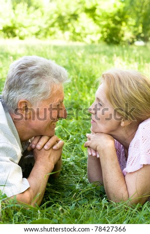 happy elderly couple  lying in a park