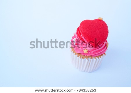 A red sweet heart cupcake on the white background. 
