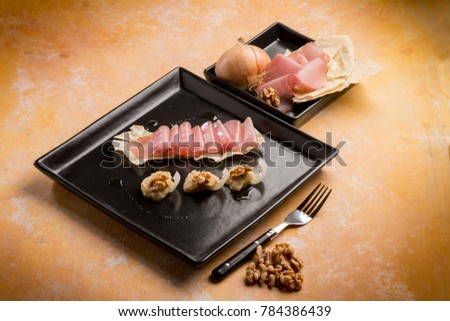 appetizer with carasau bread with ham and nuts