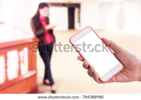 Man use mobile phone, blur image of woman using cell phones as background.