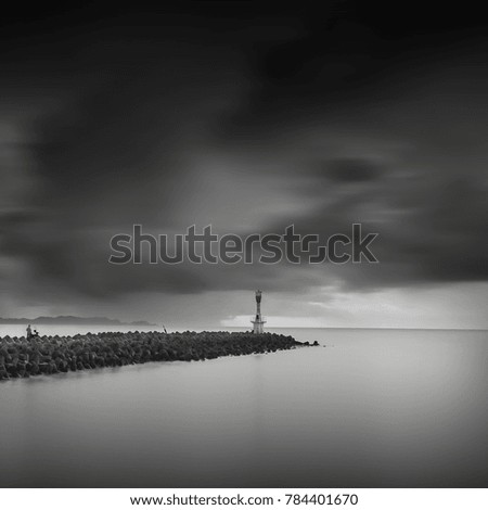 light house on a breakwater at Chendering Beach, located in Terengganu, Malaysia. long exposure photography,Soft focus effect.black and white photography