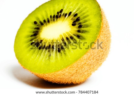 Cut half of ripe kiwi on white background close up