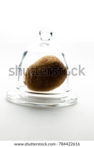 Whole kiwi covered with a glass lid