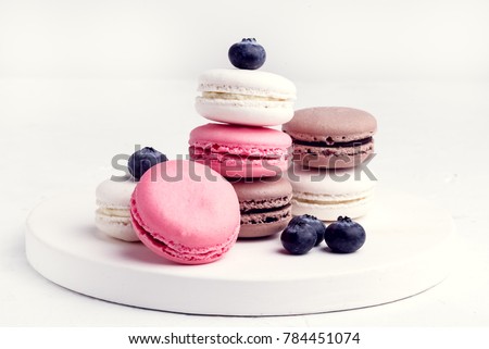 French Colorful Macarons Colorful Pastel Macarons on White Background Whitr Pink and Brown Macaron with Fresh Blueberry Royalty-Free Stock Photo #784451074