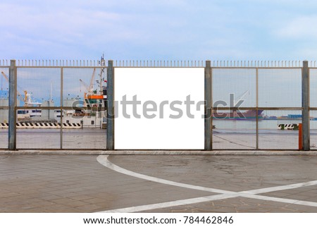 A blank billboard ready for new advertising on the harbor fence