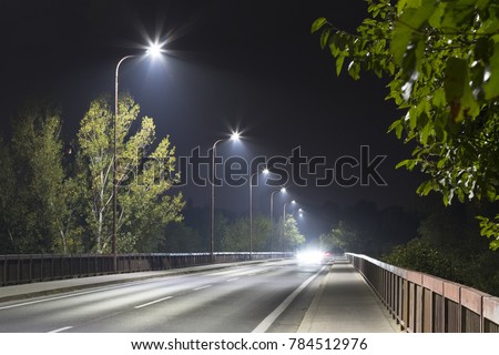 long night street with modern LED street lights Royalty-Free Stock Photo #784512976