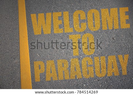 asphalt road with text welcome to paraguay near yellow line. concept
