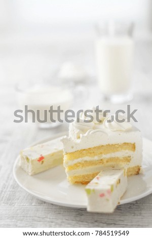 a piece of white cake on a plate, milk, cheese and marshmallows