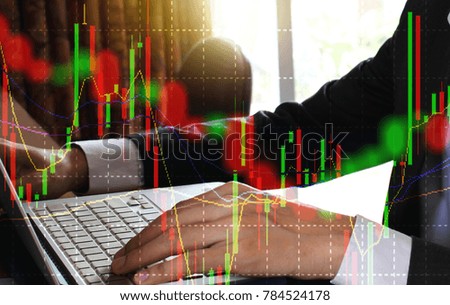 Double exposure of businessman using the laptop with stock market or financial graph for financial investment concept.
