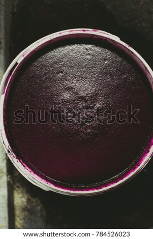Bucket with dark red paint