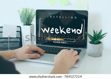 Installing weekend please wait note concept / Hands on laptop in office Royalty-Free Stock Photo #784527214