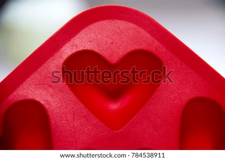 Heart shape red silicone for made ice on blur background. Decoration for Valentine's Day