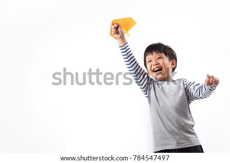 Cute Asian boy playing with paper plane, isolated on white background. Royalty-Free Stock Photo #784547497